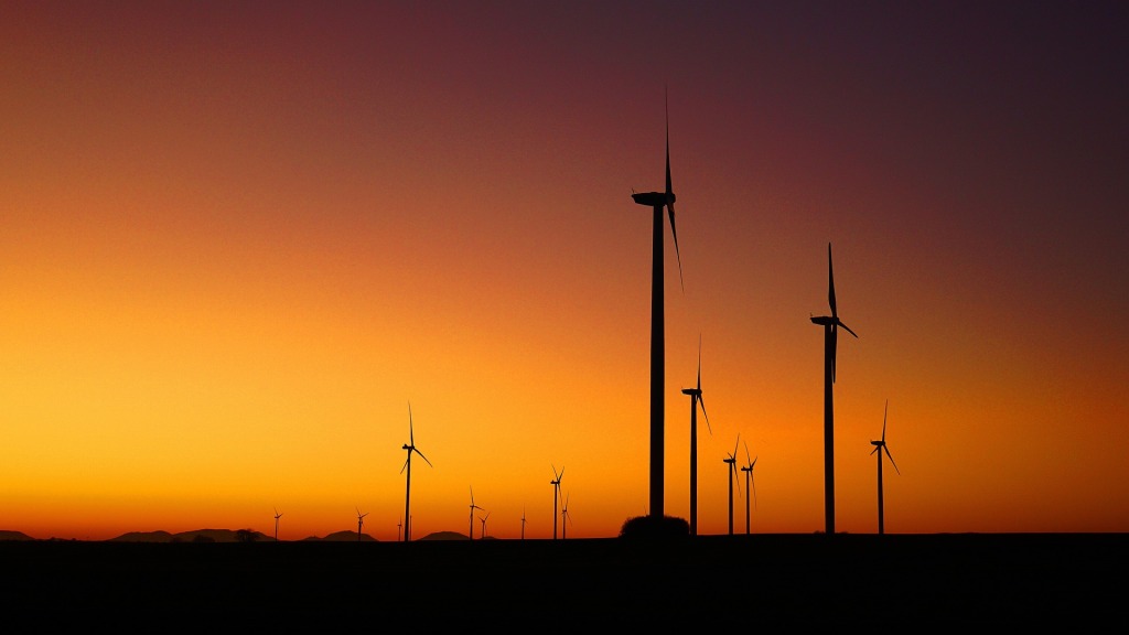 silhouette of windmills before a sunset sky